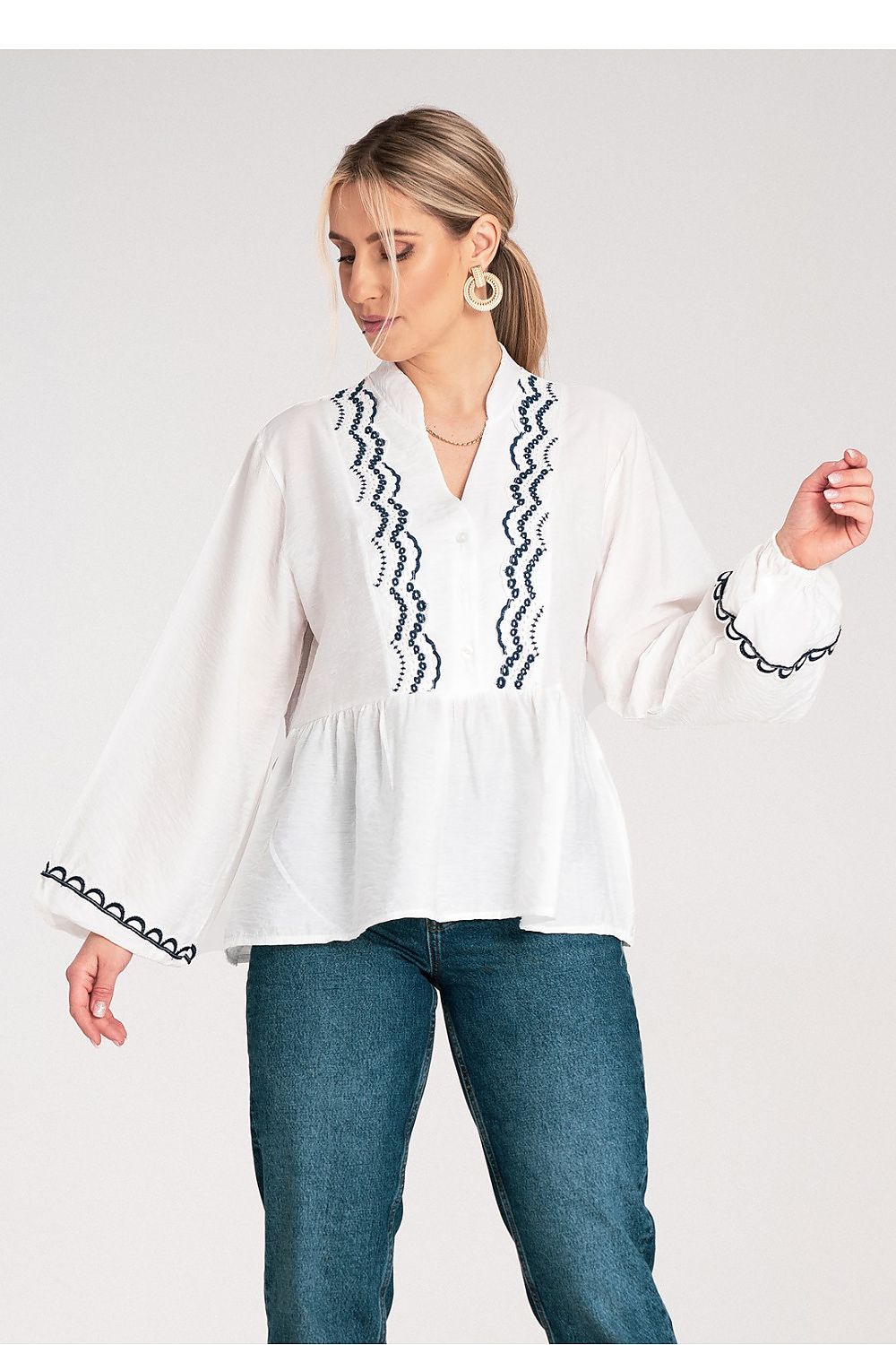 White embroidered blouse with V-neck and dark zigzag trim, peplum hem and cuffs