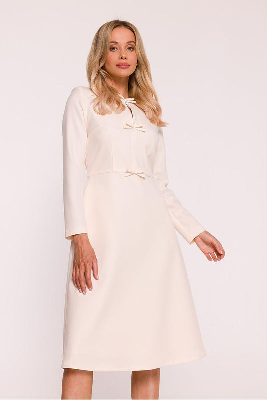 Ivory daydress with long sleeves and tie-front neckline, midi length