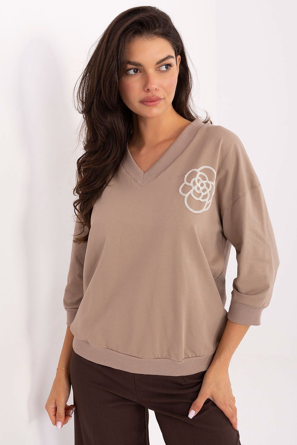 Beige cotton blouse with V-neck and embroidered flower detail at chest