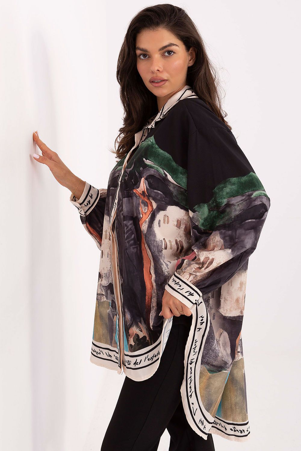 Women’s long sleeve shirt, side view, with abstract print in dark tones and green highlights