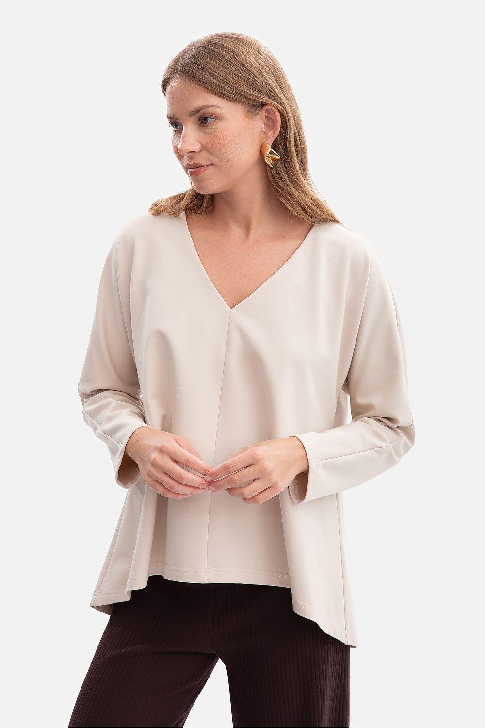 BeWear blouse in beige with V-neck, 3/4 sleeves, and relaxed drape.