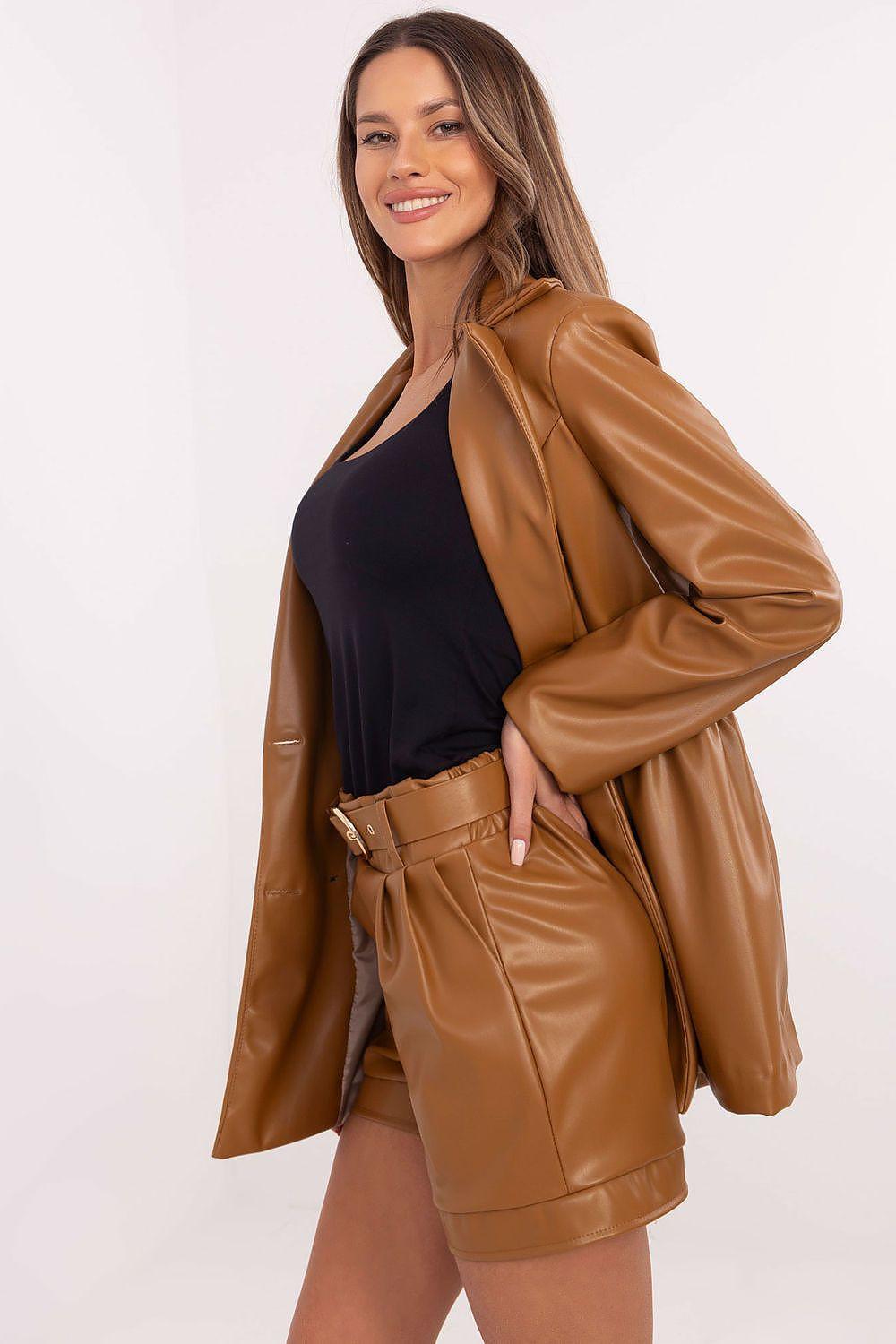 Tan faux-leather shorts with elastic waist, belt, and side pockets