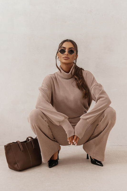 Beige two-piece set with turtleneck long sleeves and wide-leg pants, belted waist