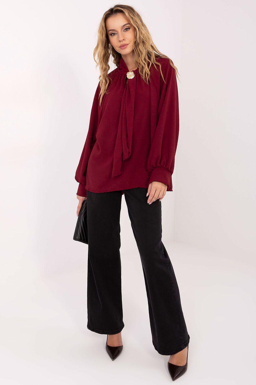 Burgundy blouse with round neckline, tie detail, gold button and long balloon sleeves