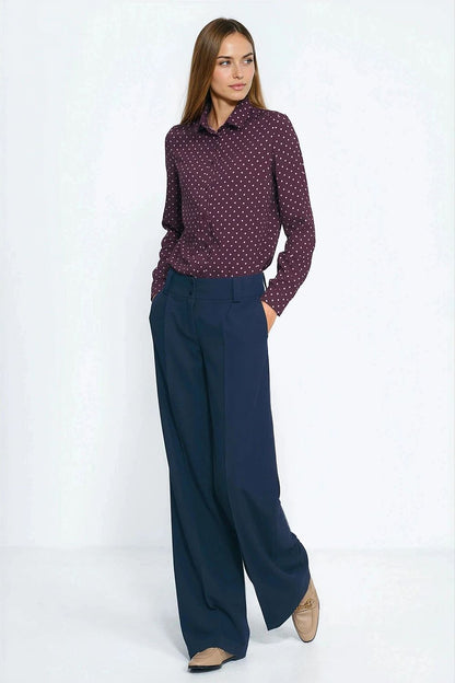 Long-sleeve polka dot shirt in burgundy, worn with dark trousers