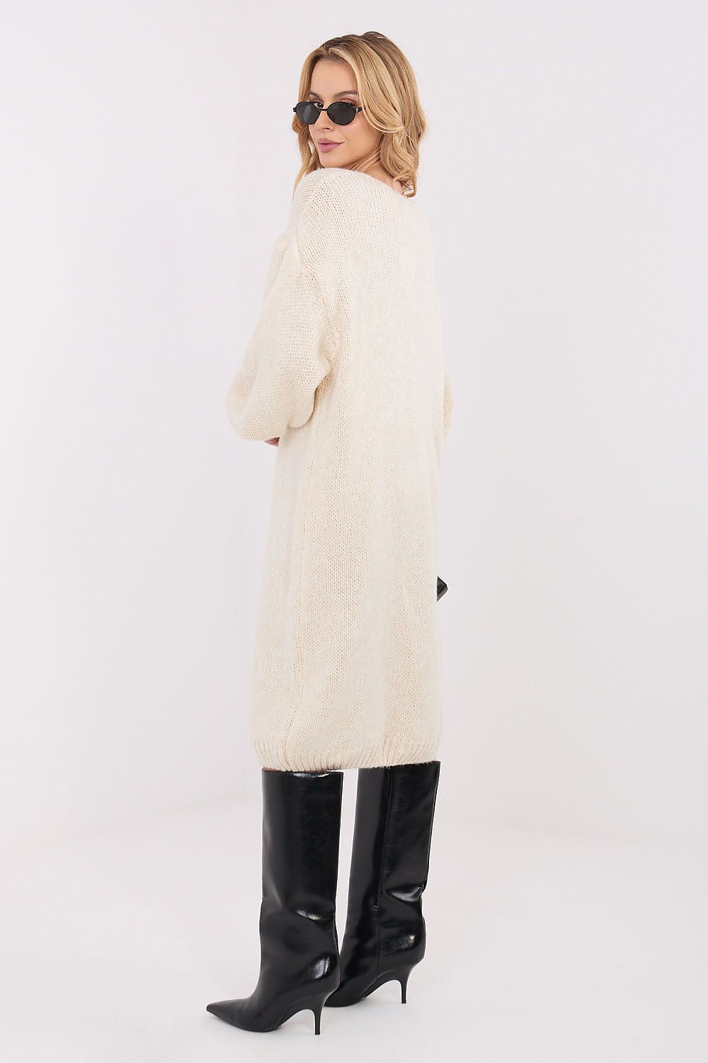 Oversized knit midi daydress in beige, V-neck, long sleeves, relaxed fit, side view.