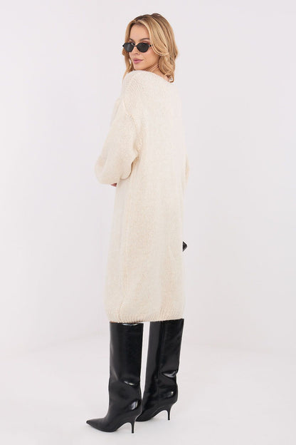 Oversized knit midi daydress in beige, V-neck, long sleeves, relaxed fit, side view.