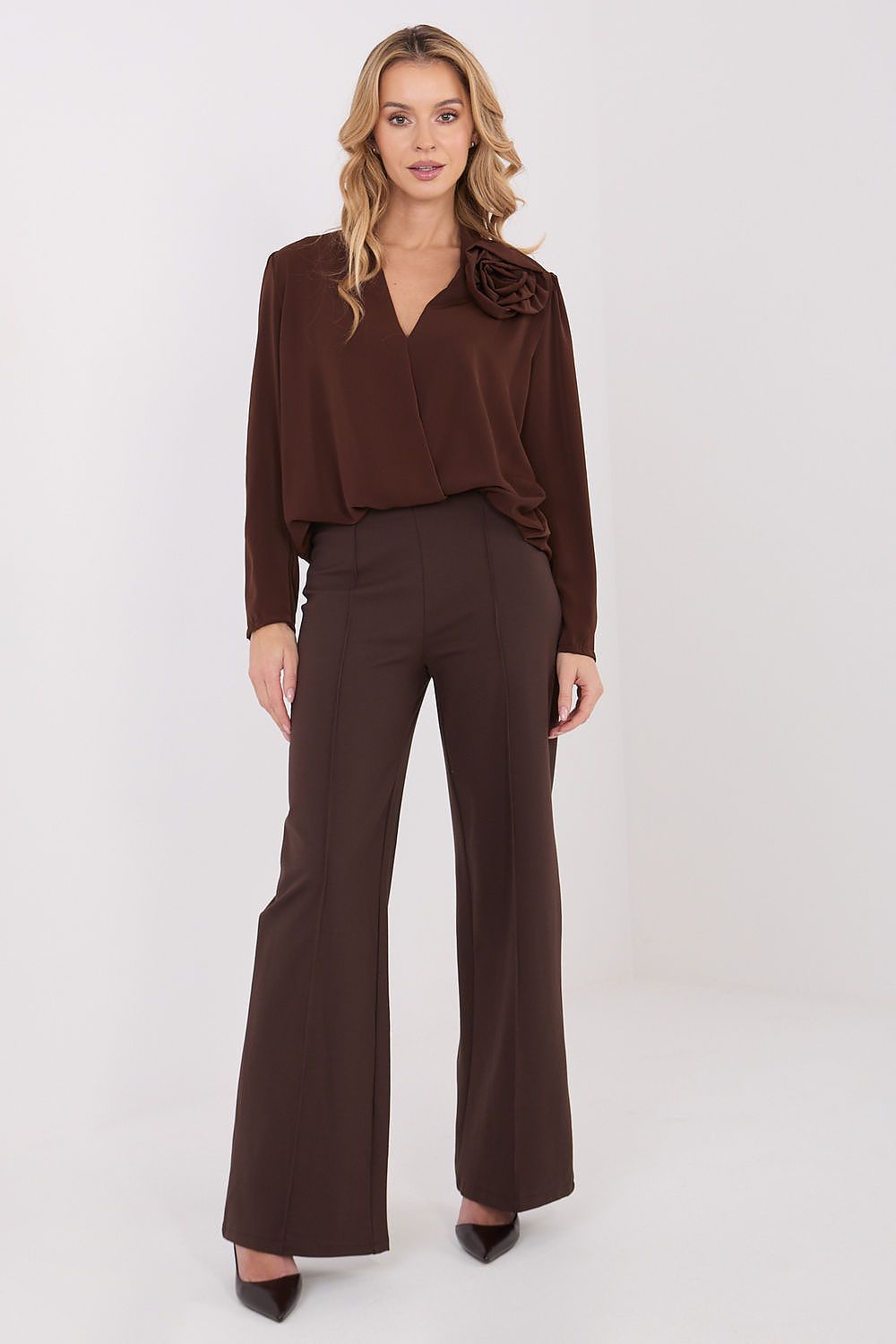 Brown long-sleeve blouse with V-neck and rosette shoulder detail