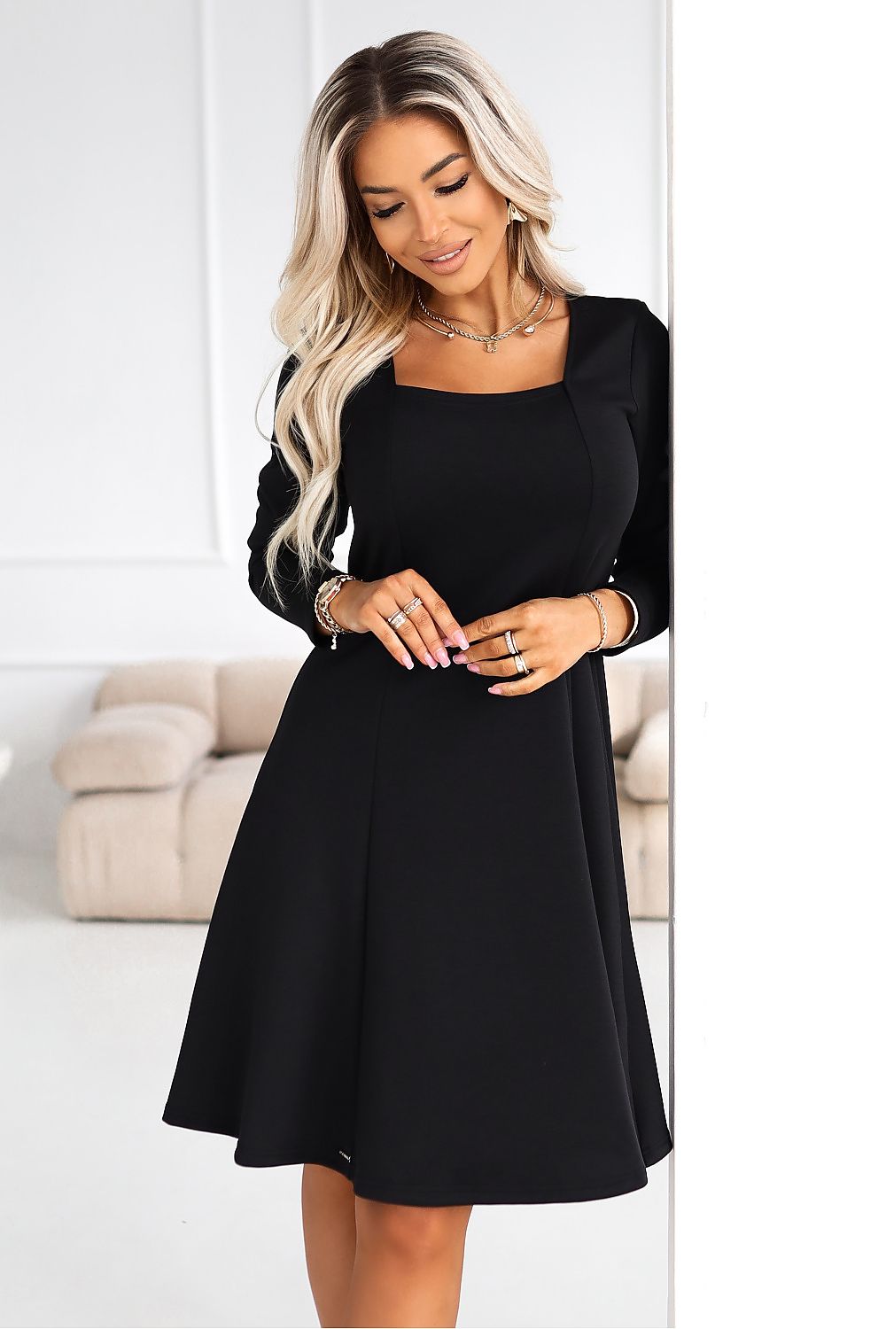 Black flared long-sleeve daydress with square neckline and fitted waist