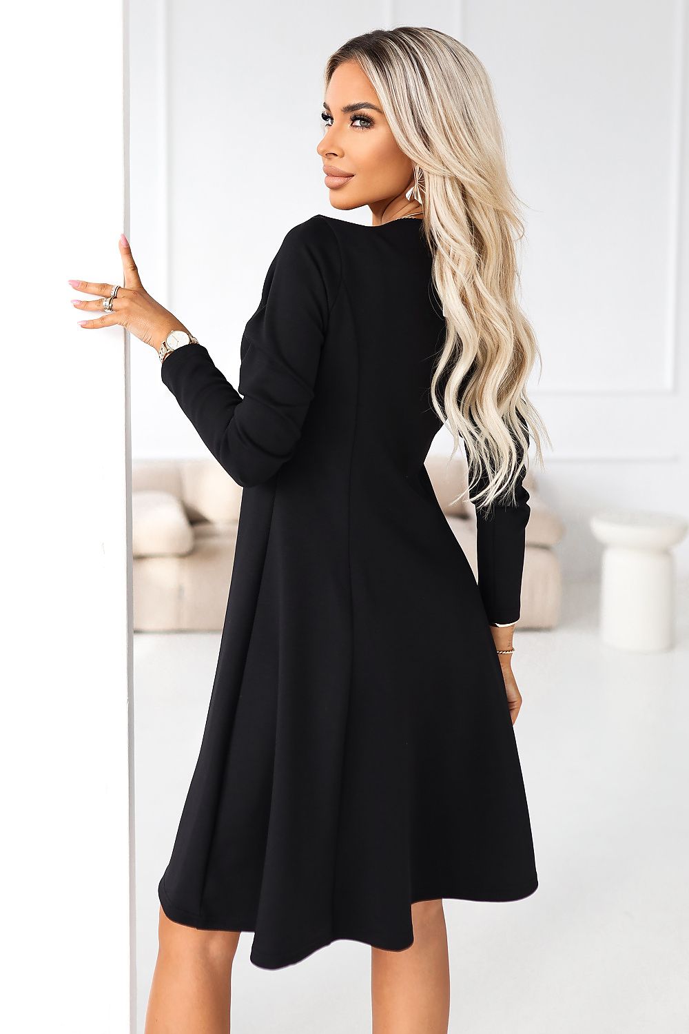 Black flared long-sleeve daydress, side view with long sleeves