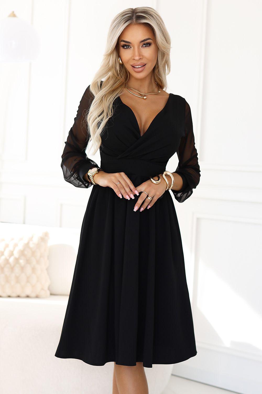 Black evening dress with V-neck, sheer long sleeves, belted waist, midi skirt