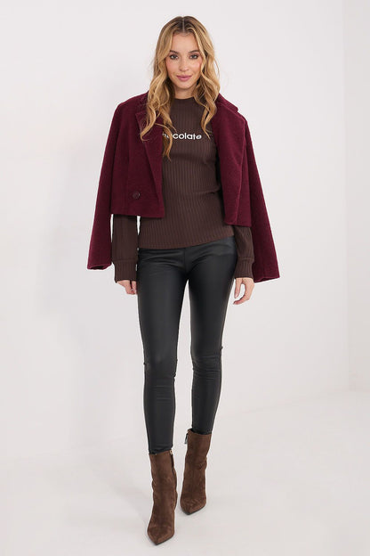 Burgundy open jacket over a dark brown ribbed long-sleeve blouse