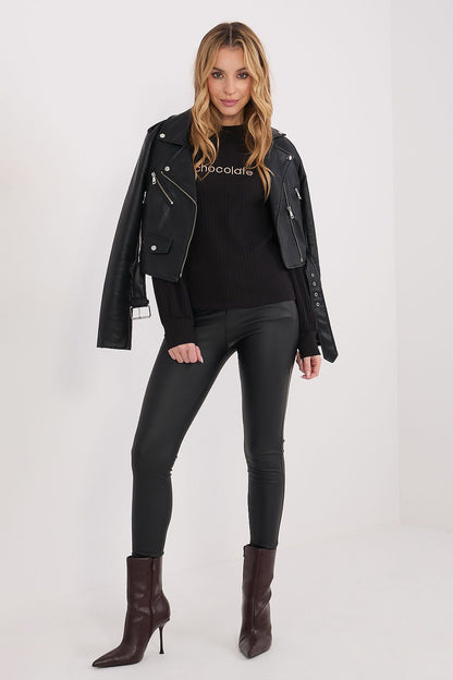 Black moto-style jacket over a black ribbed long-sleeve blouse with crew neck
