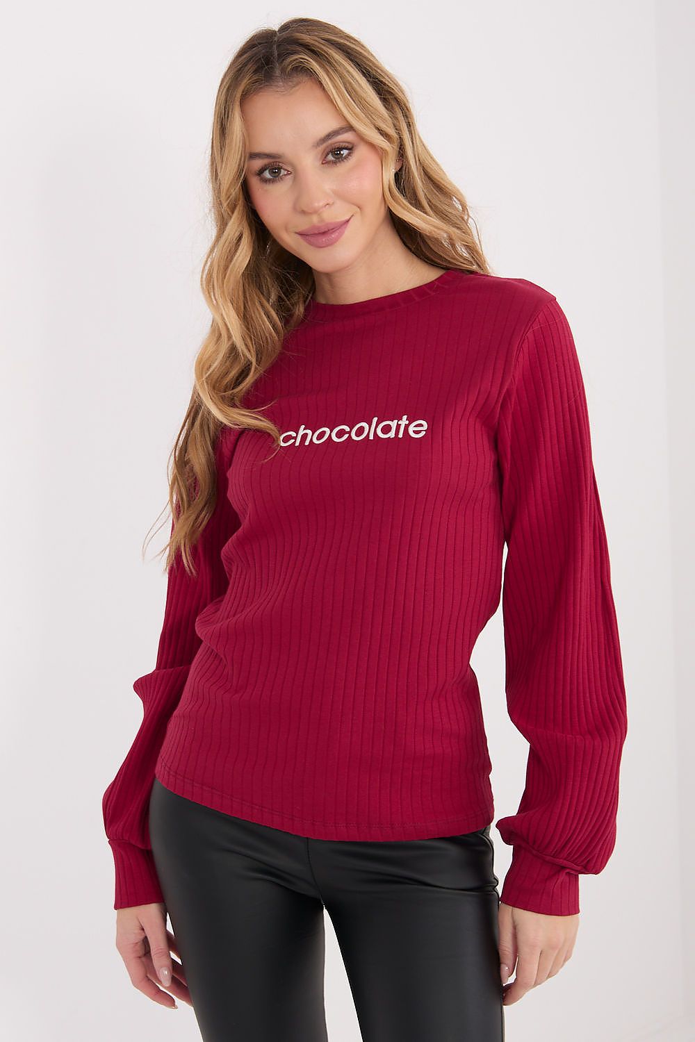 Red long-sleeve blouse with ribbed knit texture and small front embroidery