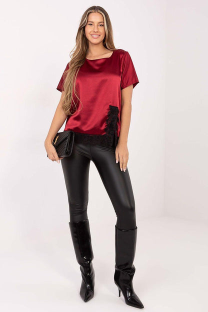 Red satin blouse with round neckline, short sleeves, and black lace hem