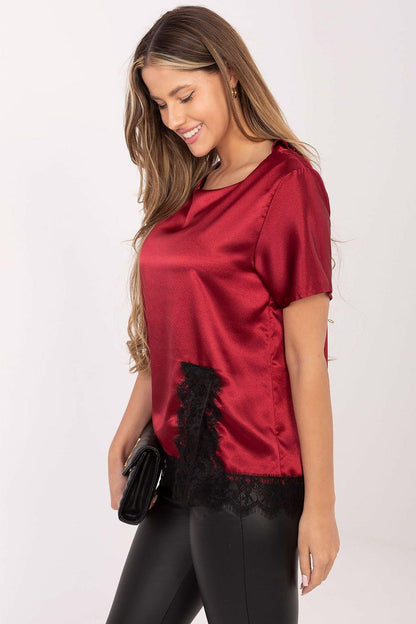 Red satin blouse with short sleeves and black lace hem detail on the front