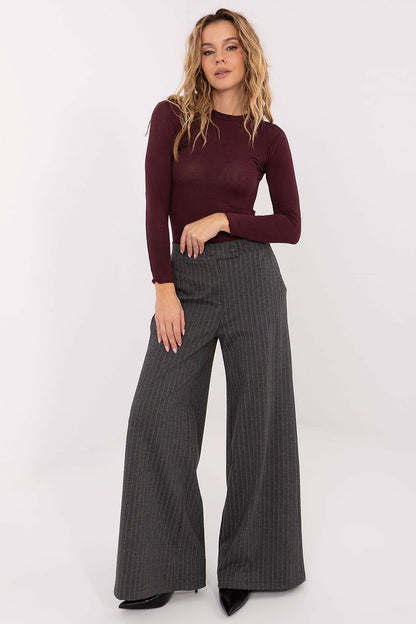 Burgundy long-sleeve blouse with crew neck, fitted sleeves, and straight hem