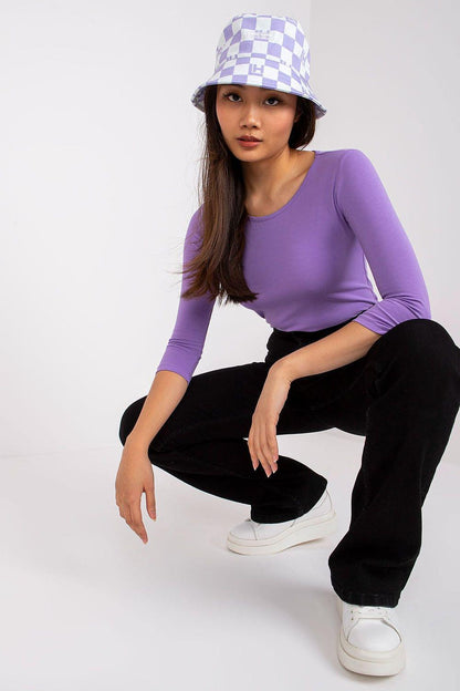 Purple long sleeve blouse with crew neck, seated pose