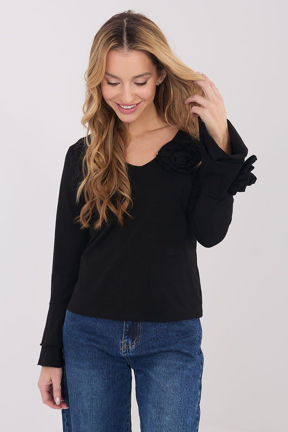 Black long-sleeve blouse with cuffed sleeves and a ruffled shoulder detail
