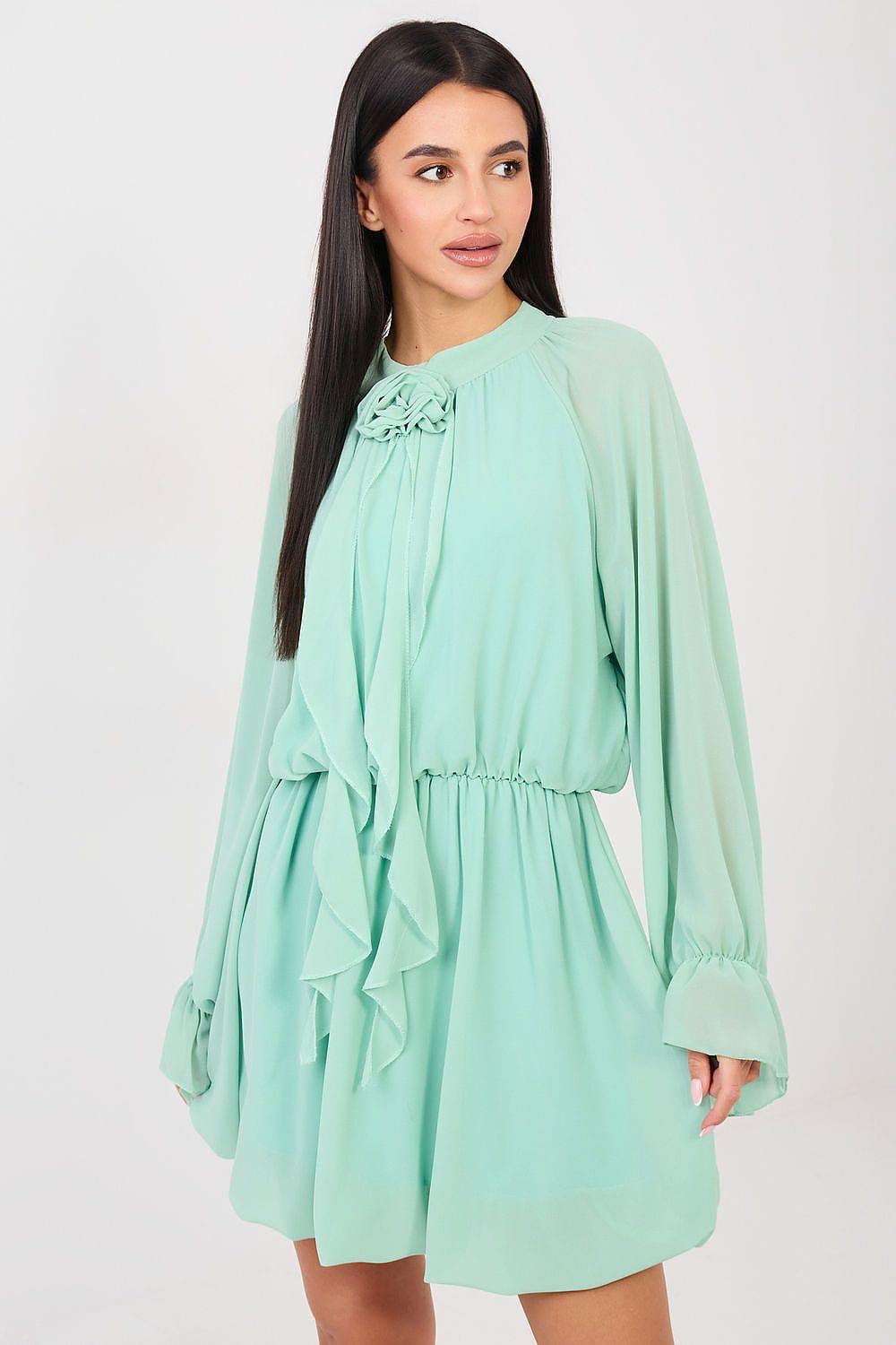 Mint green cocktail dress with ruffled neckline, tiered skirt, and long sleeves