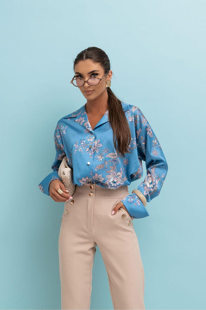 Long-sleeve button-up shirt in blue with floral print and spread collar