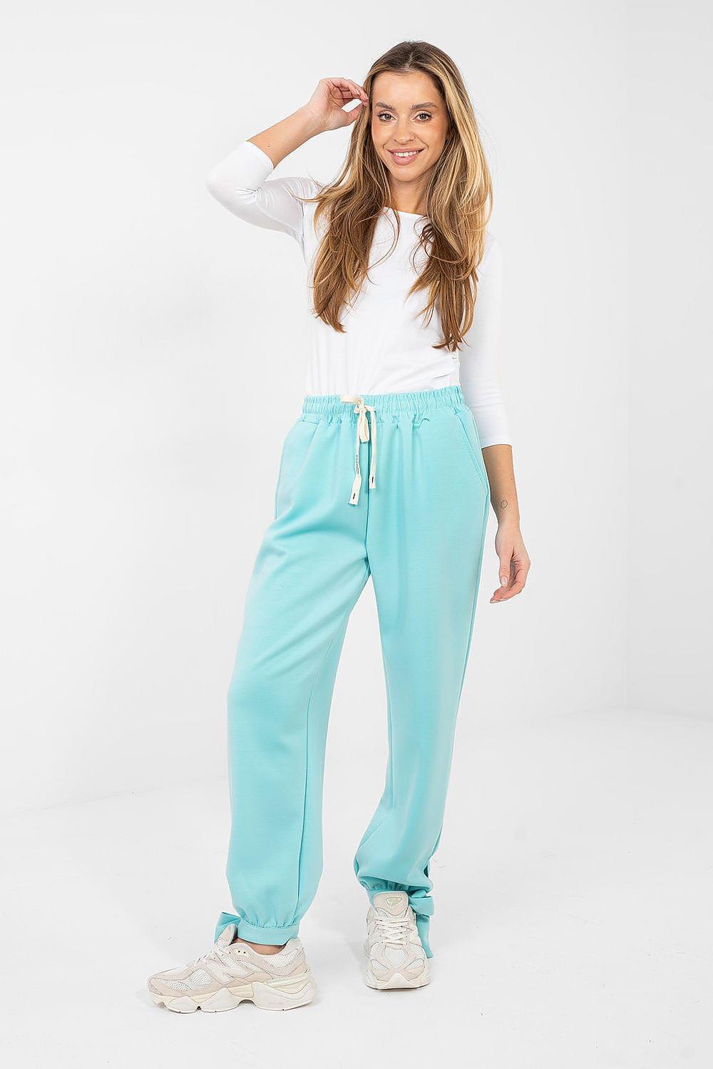 Teal track trousers with drawstring waist and tapered cuffs with ties