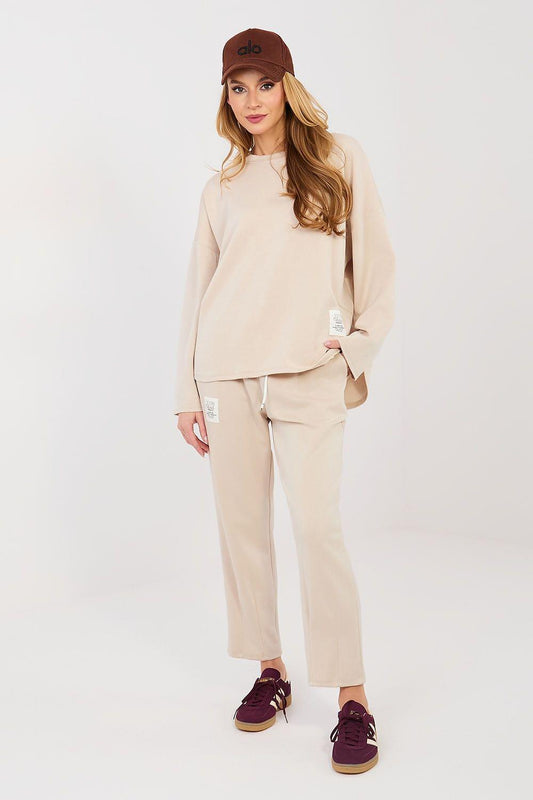 Beige two-piece lounge set with long-sleeve top and straight-leg cropped pants