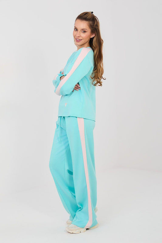 Turquoise heart-print top and relaxed pants, side view