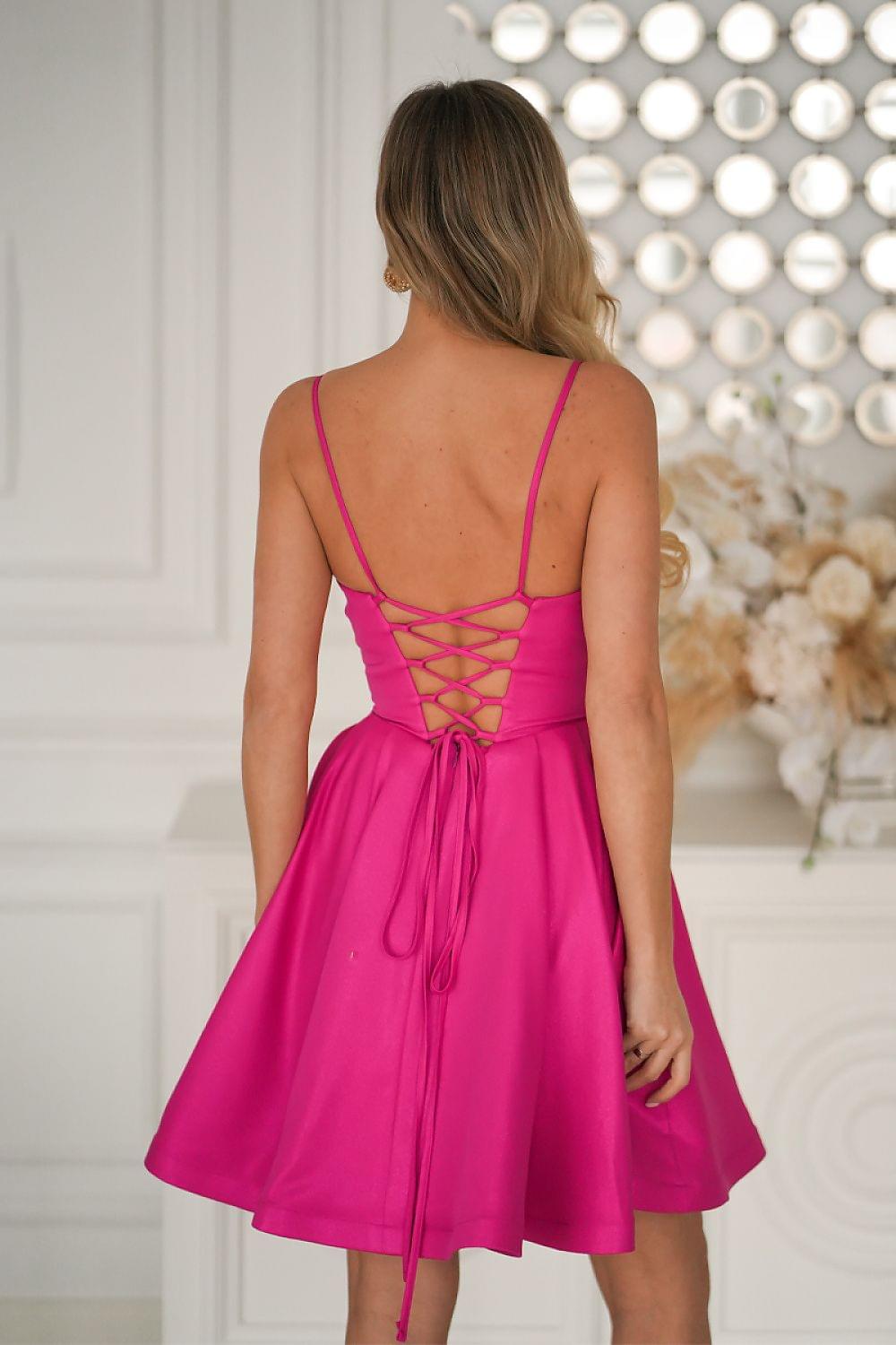 Fuchsia short dress back view with crisscross lace-up straps and flared skirt