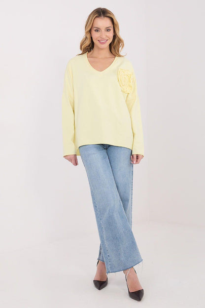 Yellow long-sleeve blouse with V-neck and embroidered rosette on left chest