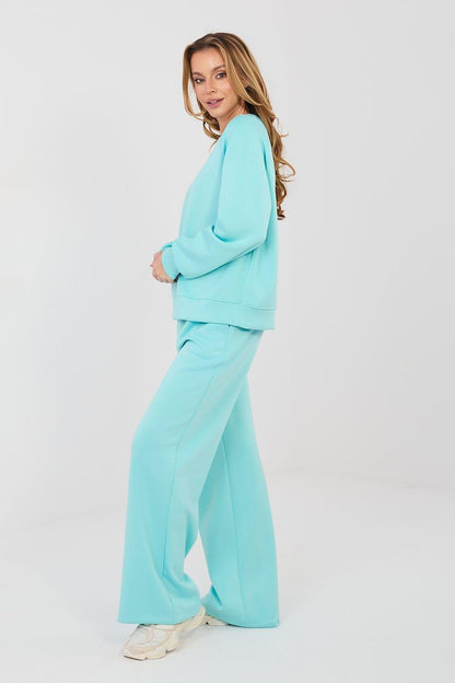 Light teal crewneck sweatshirt and wide-leg pants two-piece set, walking pose