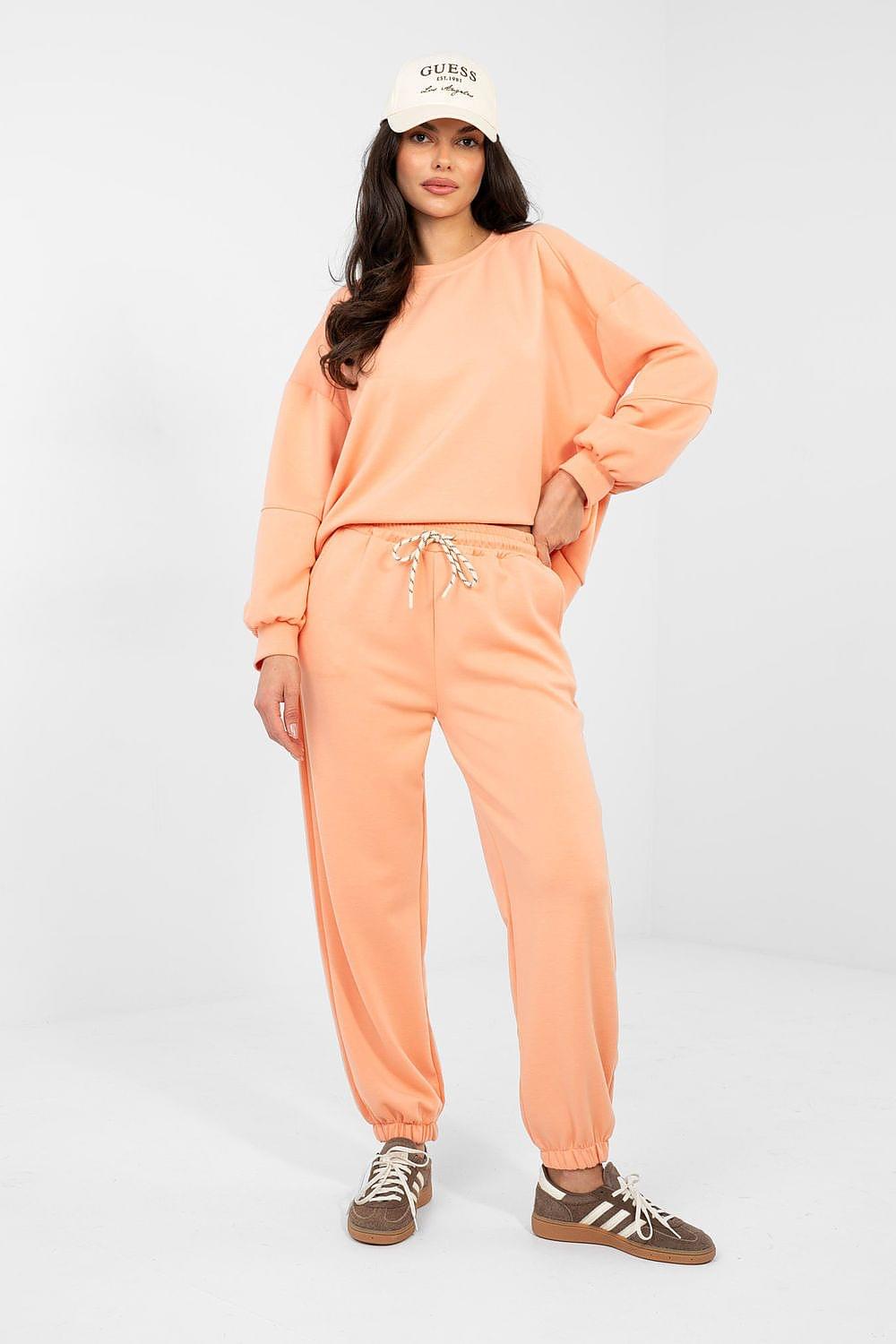 Peach sweatshirt and jogger set with crewneck, elastic cuffs, and drawstring waist