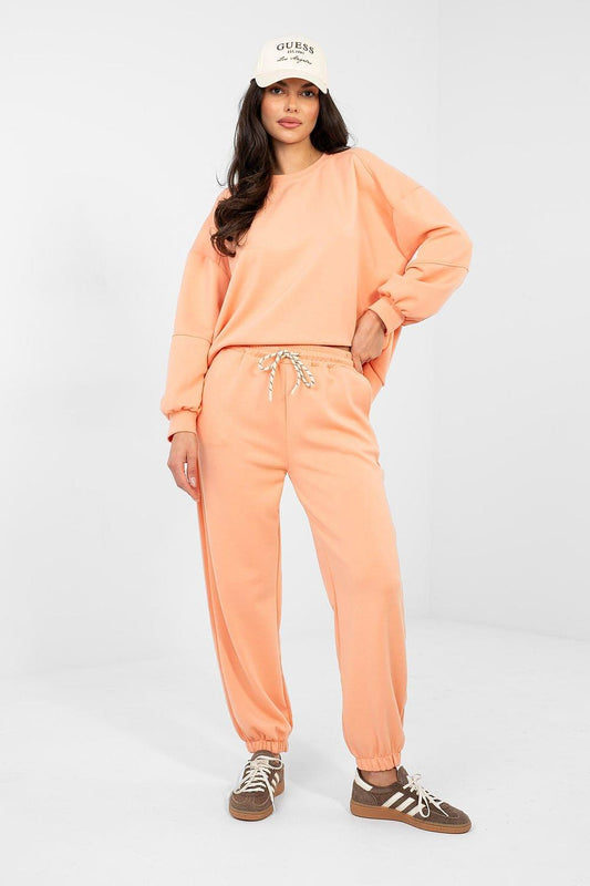 Peach sweatshirt and jogger set with crewneck, elastic cuffs, and drawstring waist