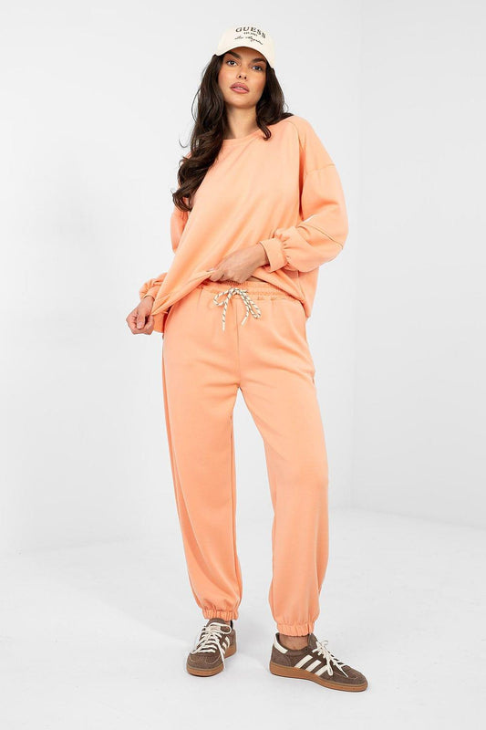 Peach sweatshirt and jogger set with crewneck and drawstring waist, elastic cuffs