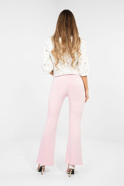 Pink flared tracksuit trousers, wide-leg fit with elastic waistband, back view.