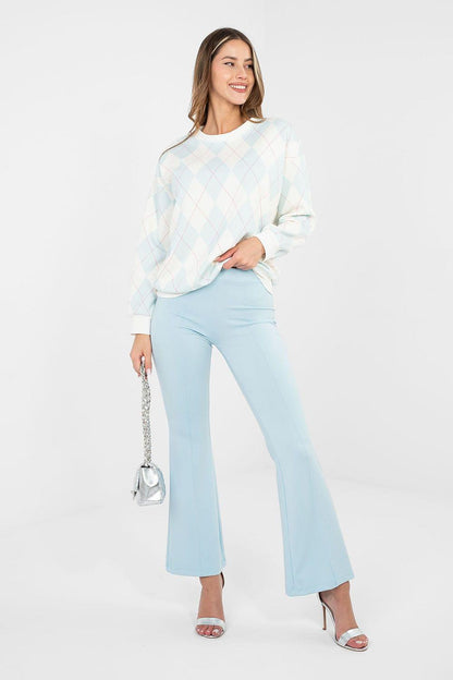 Light blue wide-leg tracksuit trousers with flared hem and elastic waistband.