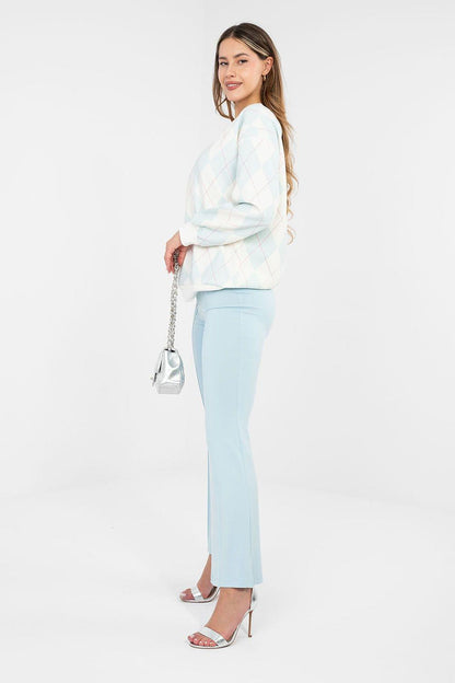 Light blue flared tracksuit trousers with wide legs and elastic waistband, side view.