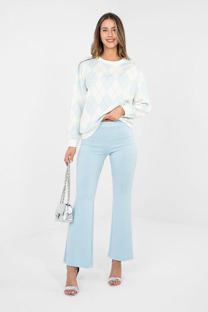 Light blue flared tracksuit trousers with wide legs and elastic waistband, full length.