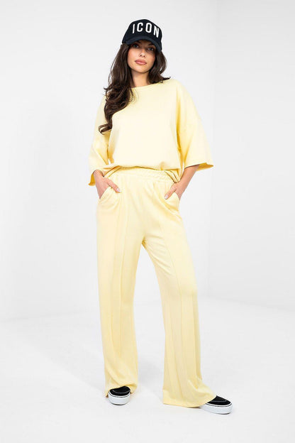 Pale yellow tracksuit trousers, wide-leg with elastic waistband
