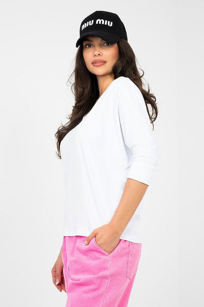 White V-neck blouse with 3/4 sleeves and relaxed silhouette