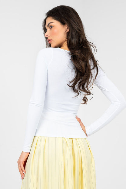 White long-sleeve blouse with scoop neckline, fitted at waist, side view