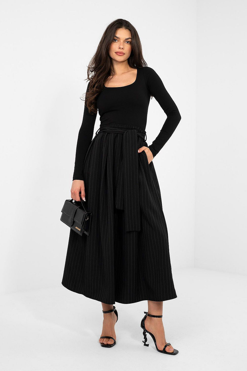 Black long-sleeve blouse with scoop neckline, fitted waist, full-length view