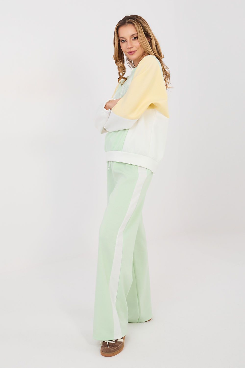 Sweatshirt and pants set with pale yellow top and mint-green flared trousers