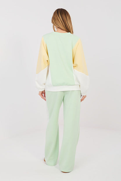 Back view of sweatshirt and pants set in pale yellow with mint-green trousers