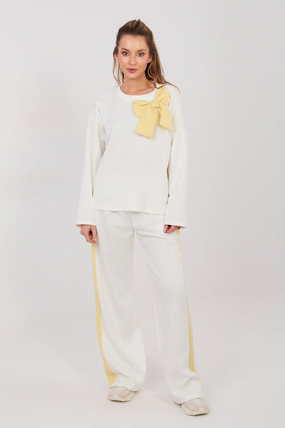 White two-piece set with long-sleeve blouse and wide-leg pants, yellow bow detail