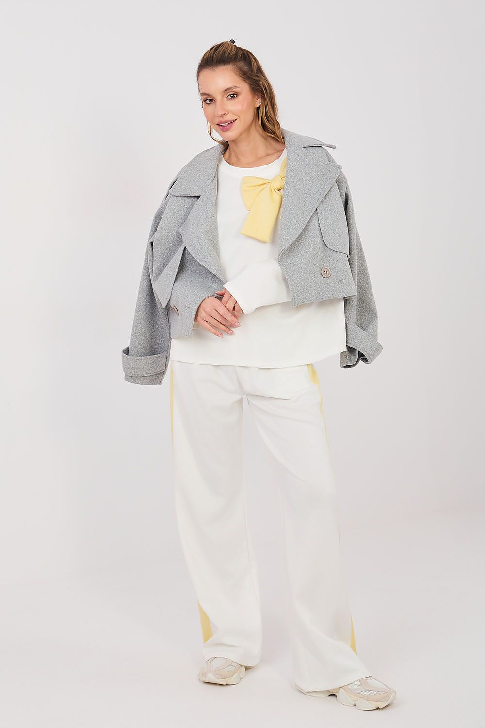 White two-piece set with long-sleeve blouse and wide-leg pants, gray jacket overlay