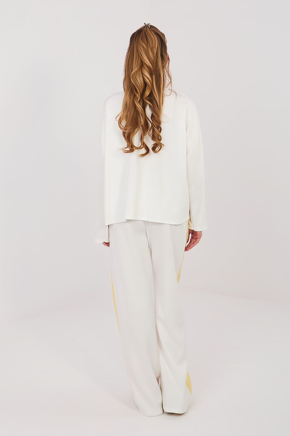 White two-piece set with long-sleeve blouse and wide-leg pants, side bow accents