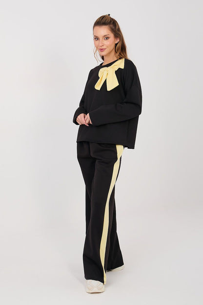 Black two-piece set with long sleeves and yellow bow, wide-leg pants with stripe