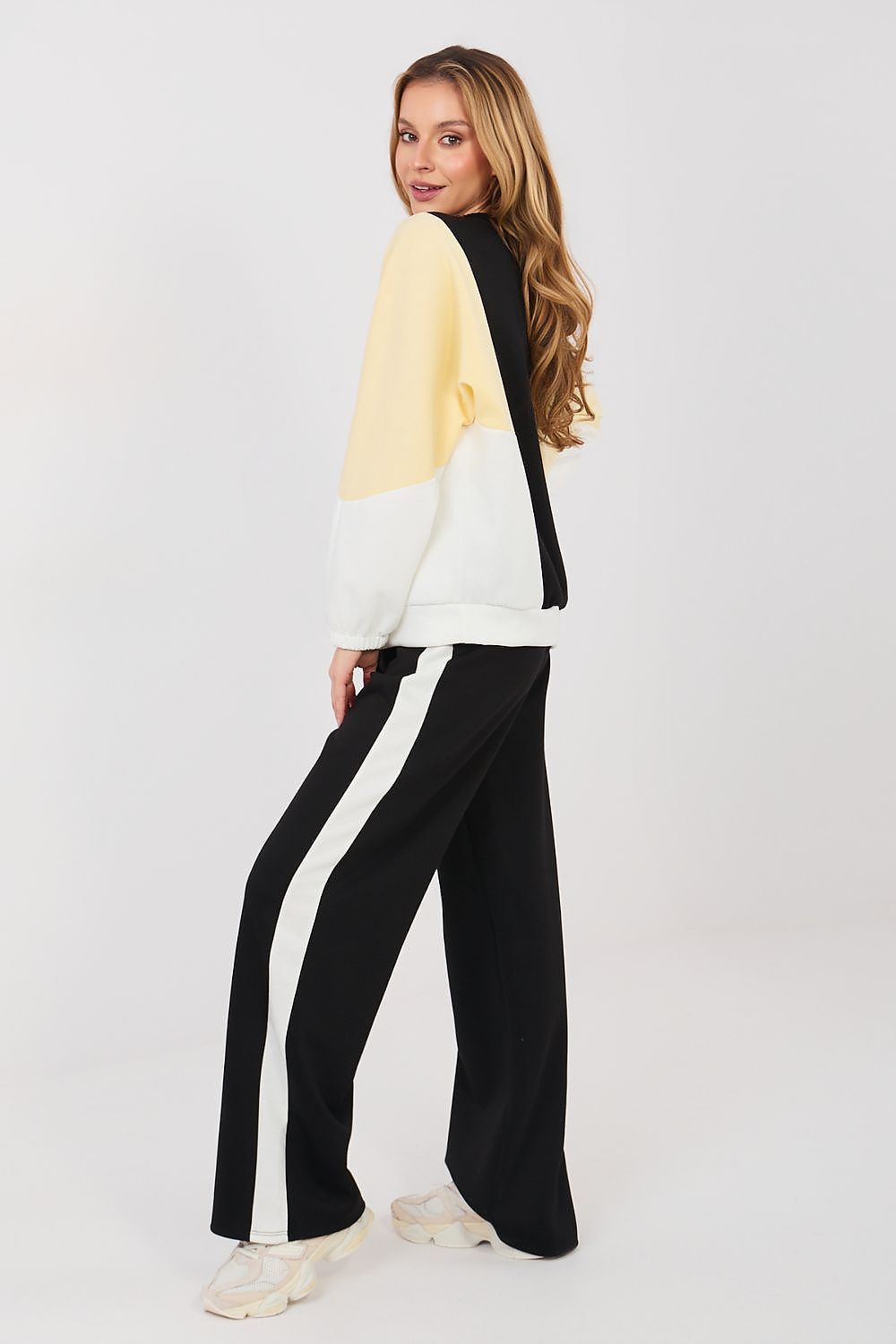 Sweatshirt and pants set with cream yoke, black pants, and side stripe detailing