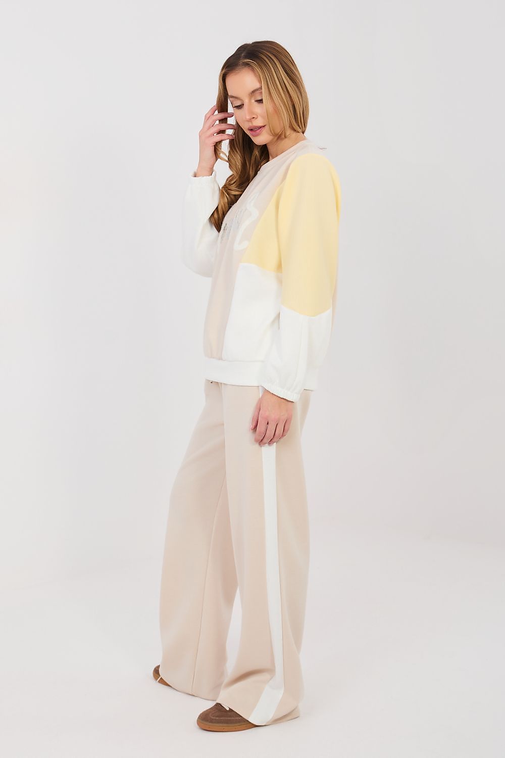 Beige two-piece lounge set with long-sleeve sweatshirt and wide-leg pants, side view